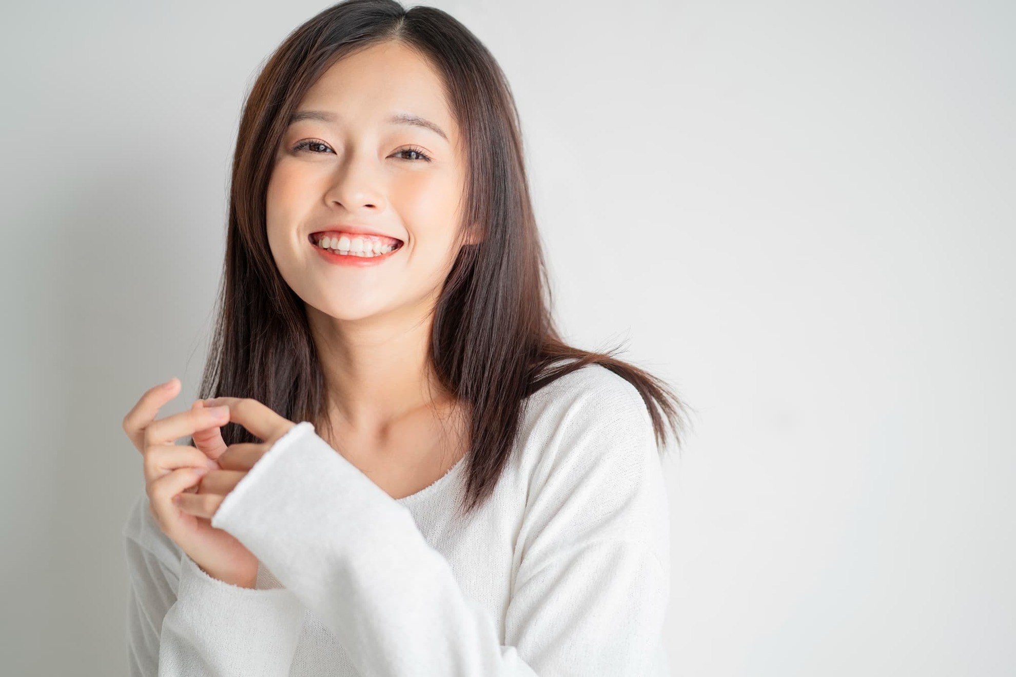 矯正治療で整った歯並びになり満足して笑う女性