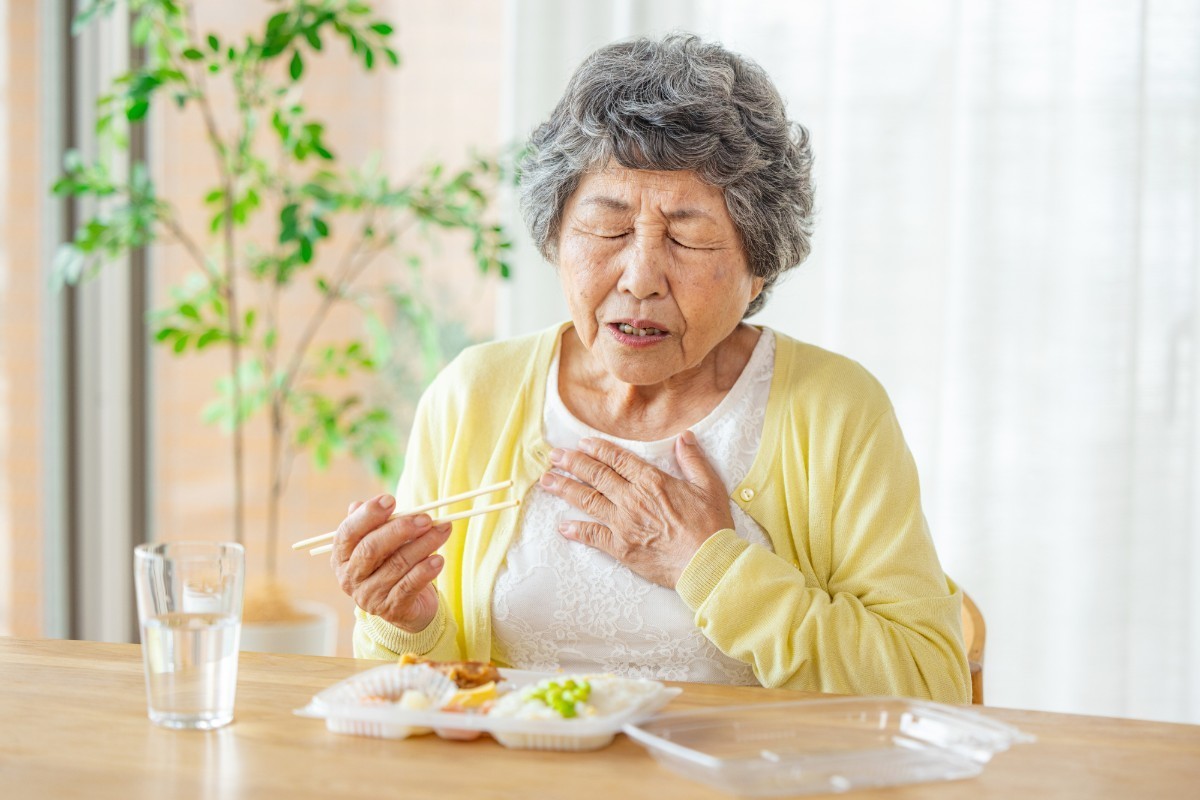 歯を失って食事が噛みにくいシニア女性